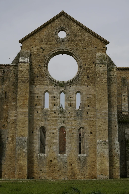 a large building made of stone and has holes in the middle of it