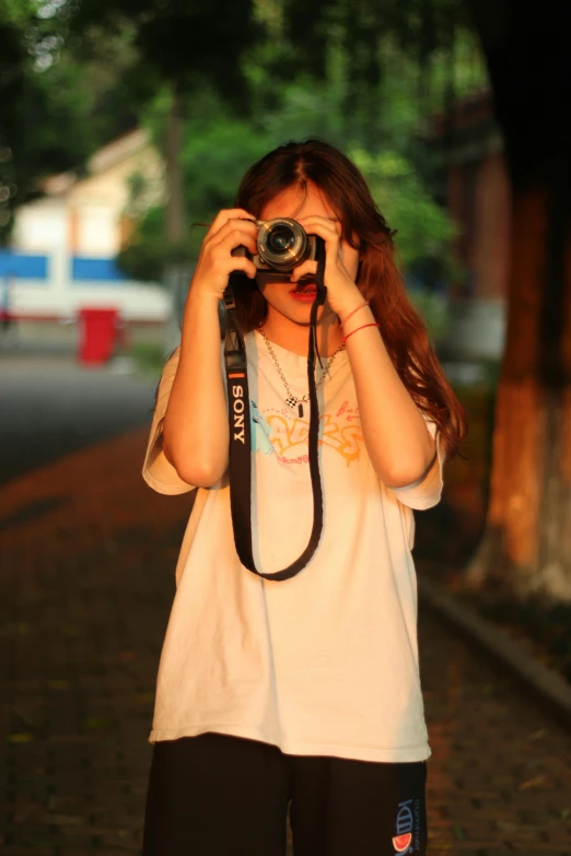 a  taking a picture with her camera