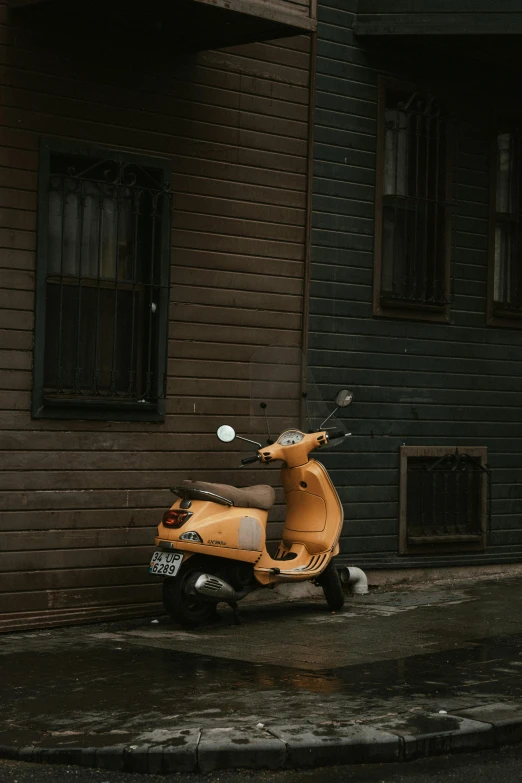 a motor scooter parked near a house on the street