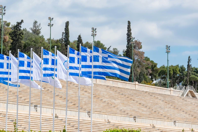 a large stadium with blue and white flags