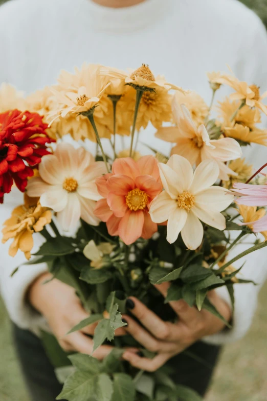 a person holding flowers in their hands