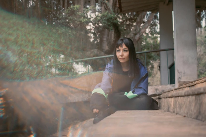 a woman sitting on the stairs of her house