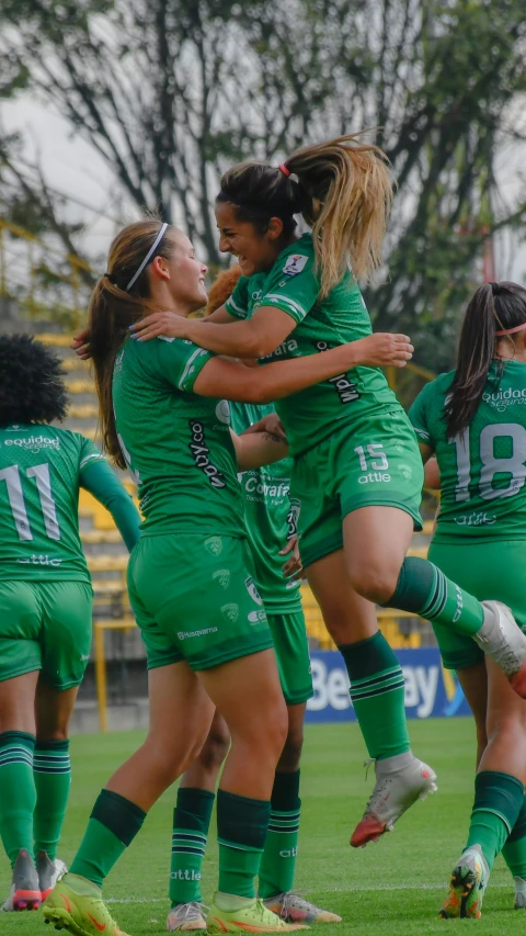 group of young women in green uniforms playing a game