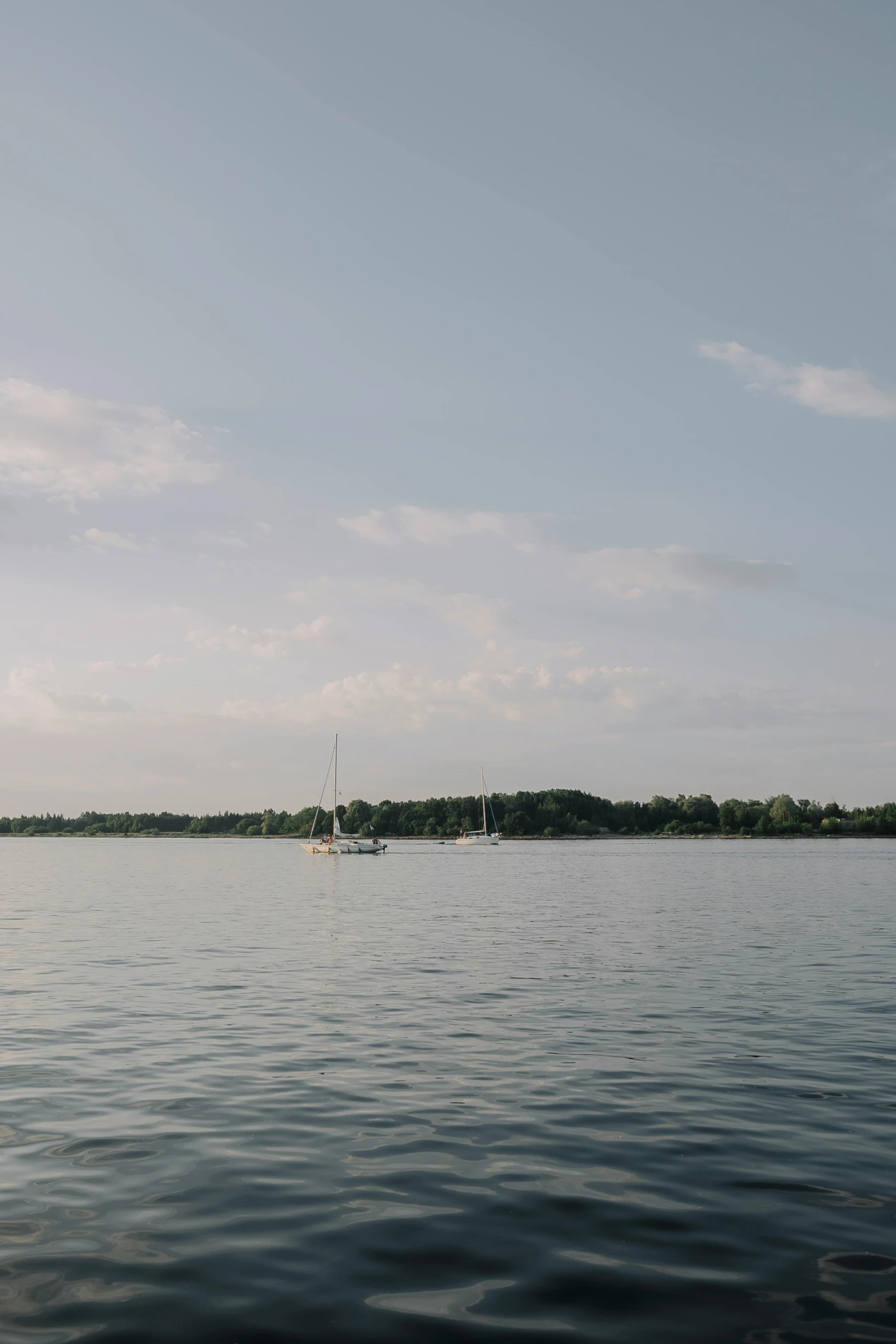 two boats on the water and a boat in the distance