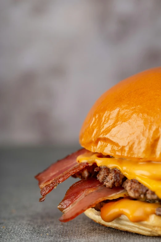 a cheeseburger with bacon is shown on a plate