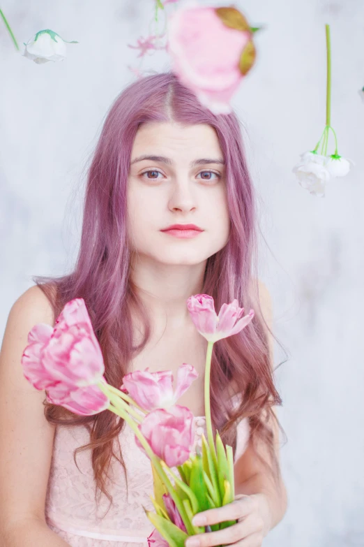 an image of a girl holding flowers near some flowers