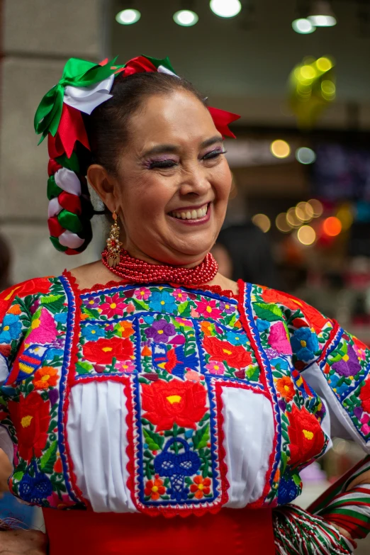 a woman in a colorfully dressed costume standing with her hand on her hip