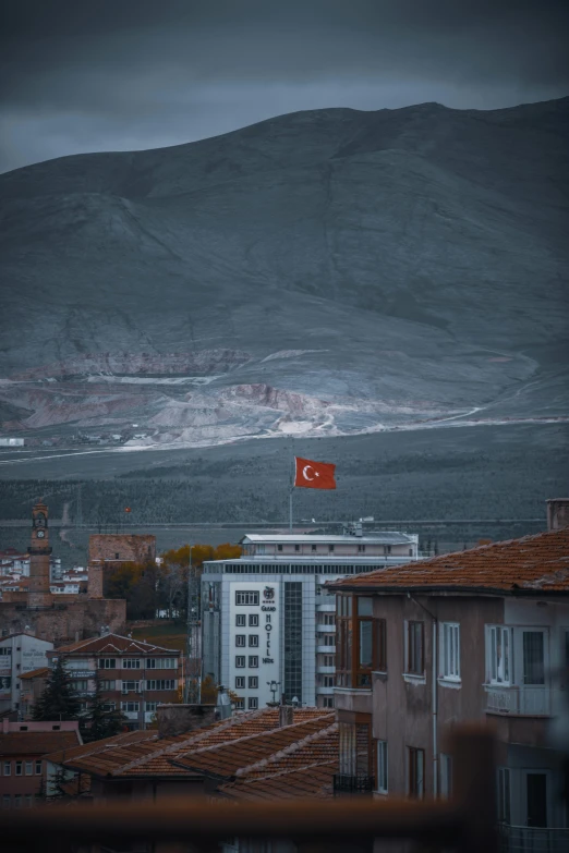 a flag on top of a building in a city