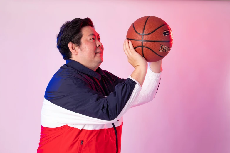 a man holding a basketball in his right hand