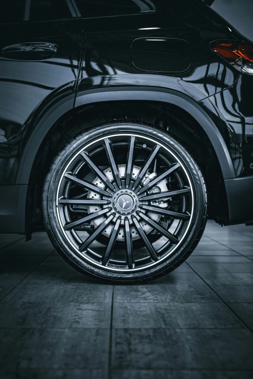 an artistic s of the front wheel of a black suv
