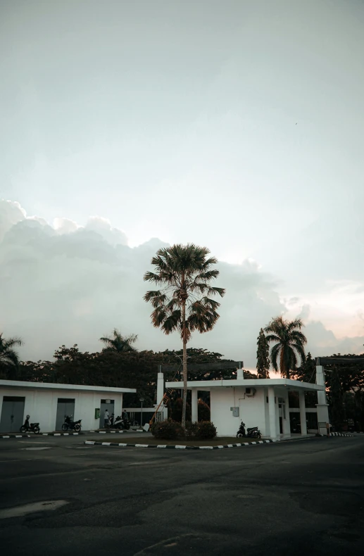 an empty parking lot with an office building on one corner