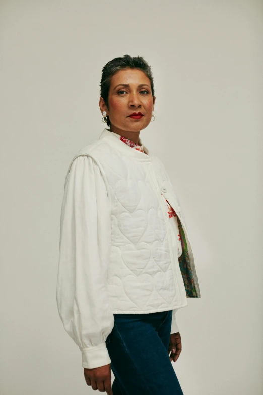 a person in a white jacket and jeans