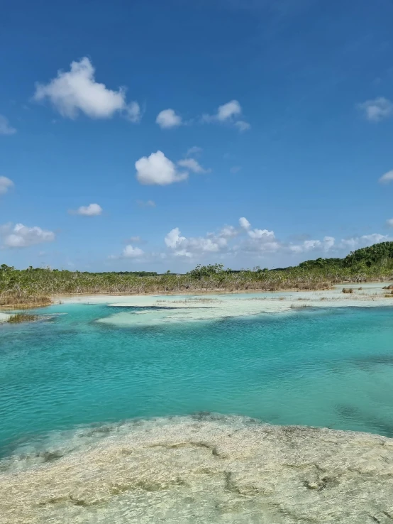 an image of some blue water on the shore