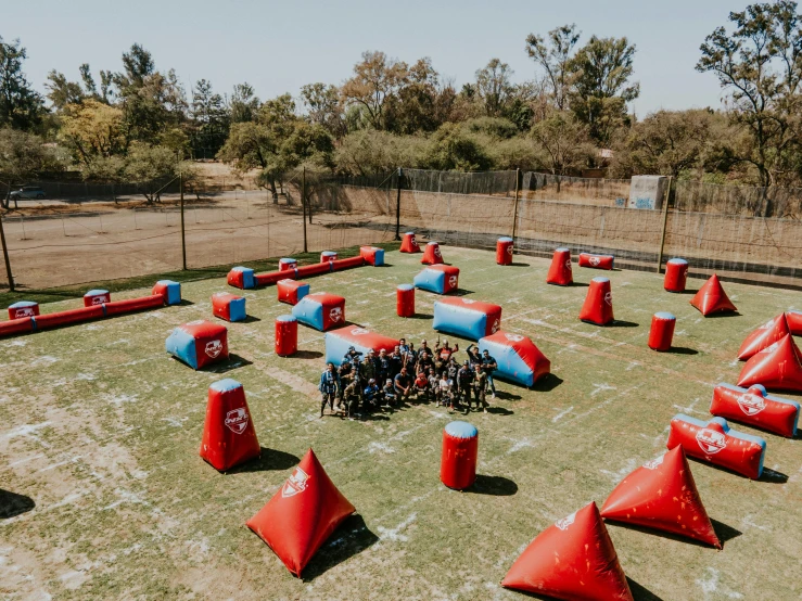 several people sitting on bean bag swings in a park area