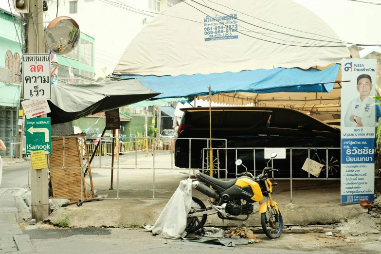 a yellow motorcycle parked in front of a business