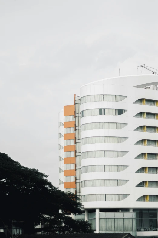 large white and orange building in front of a cloudy sky