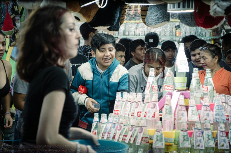 a crowd of people looking at several boxes