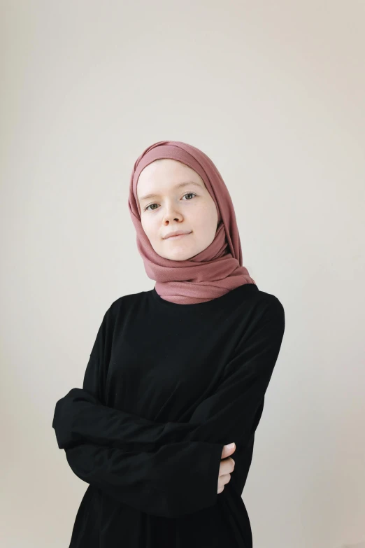 a woman standing with her arms crossed looking up