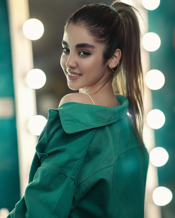 a woman with a ponytail posing in front of a mirror