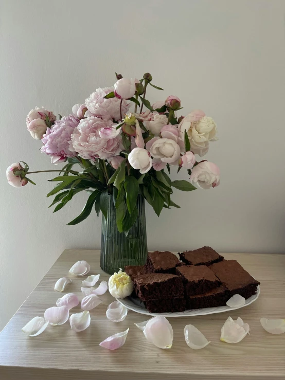 flowers and chocolate squares on a table