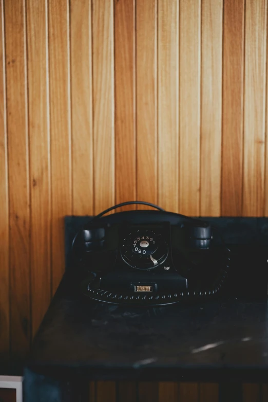 an old style clock sitting on top of a table