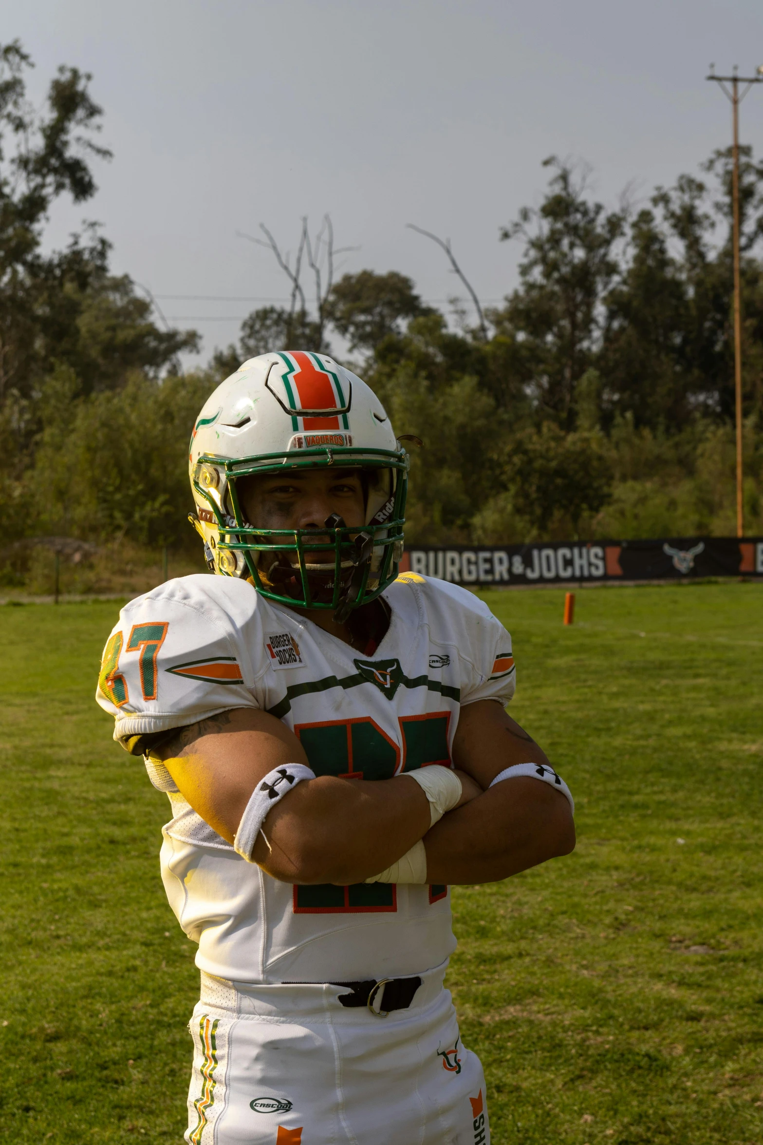 a football player wearing a green and white uniform