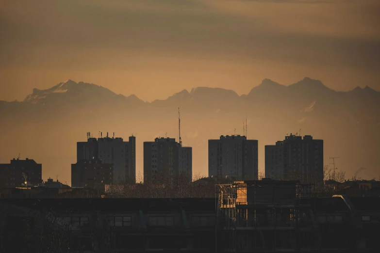 the city buildings with the mountains in the distance