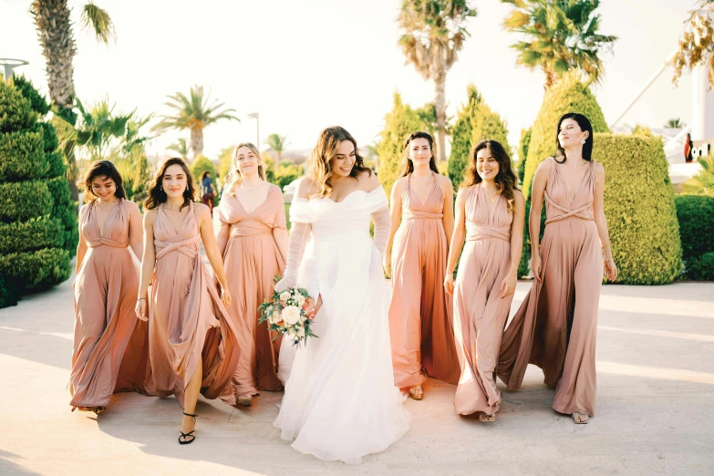 the bride and her nine bridesmaids posing for a picture