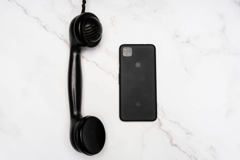 a phone sitting on top of a counter next to a hair dryer