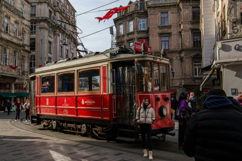 a trolley car is riding down a street