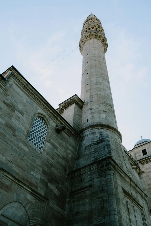 a tall tower standing above an old stone building