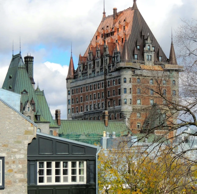 a large building on a hill with turrets on top