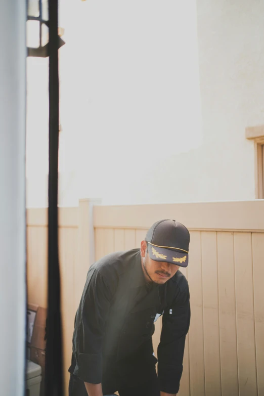 a man is posing with a skateboard in his hand