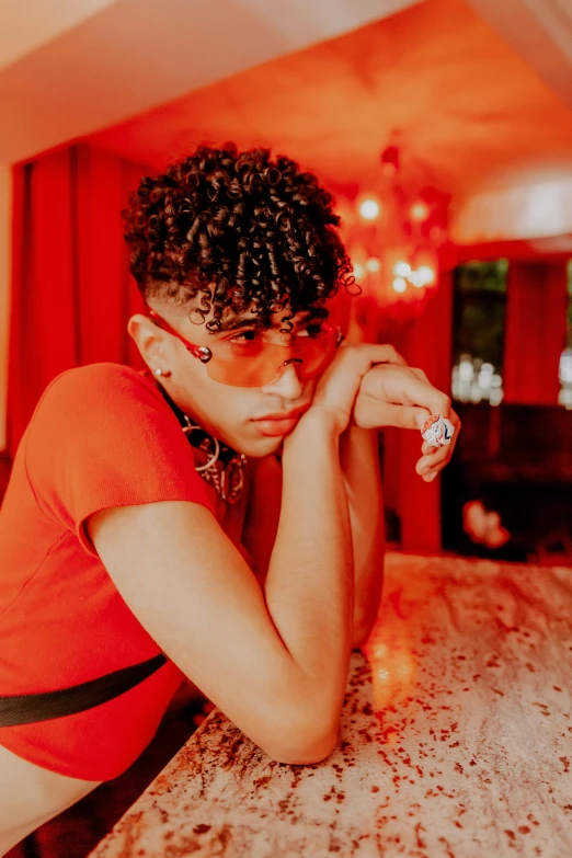 a person wearing a red shirt sits on the table