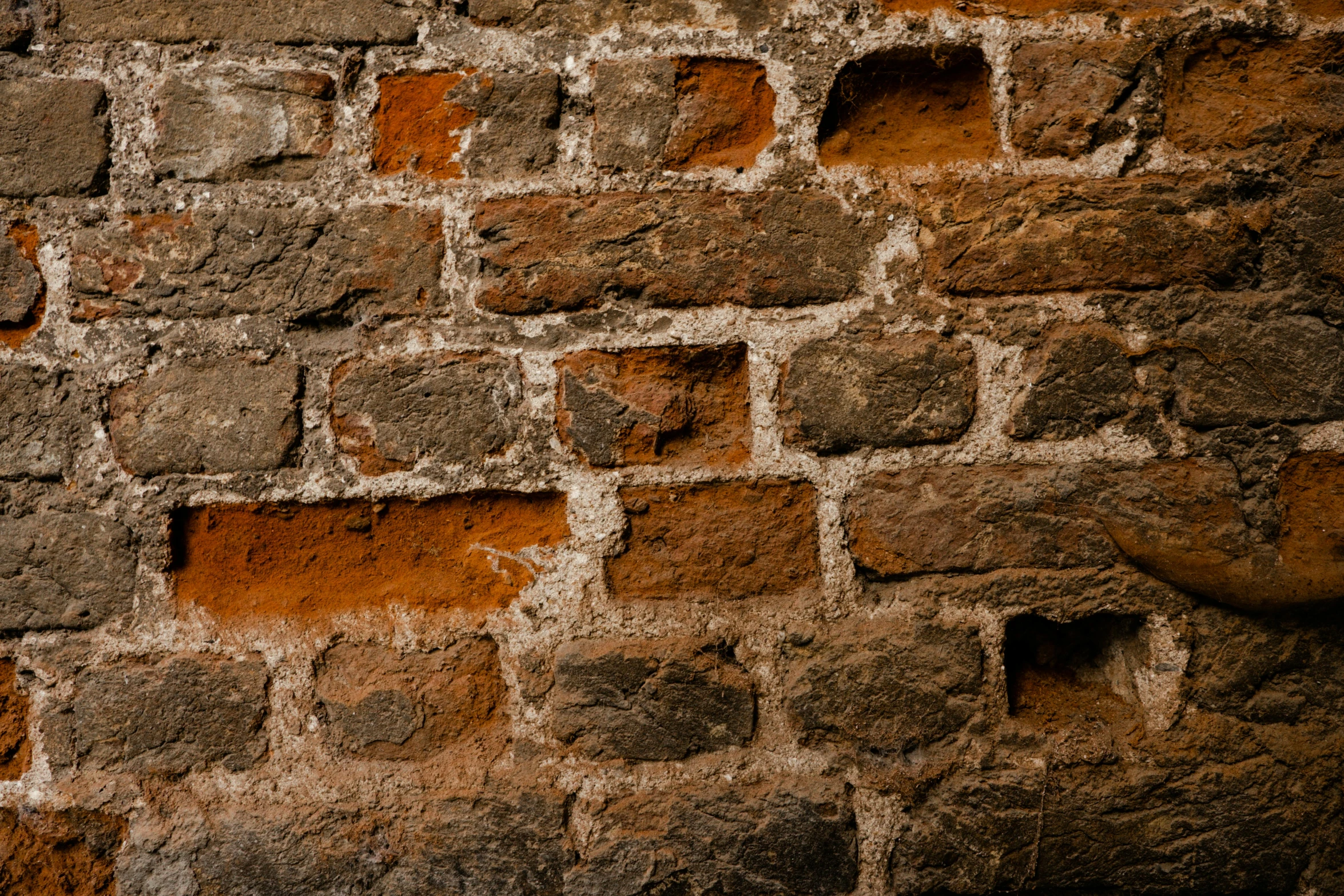 an old brick wall has orange bricks on it