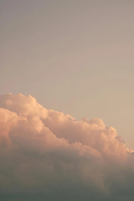 an airplane flying away in the cloudy sky