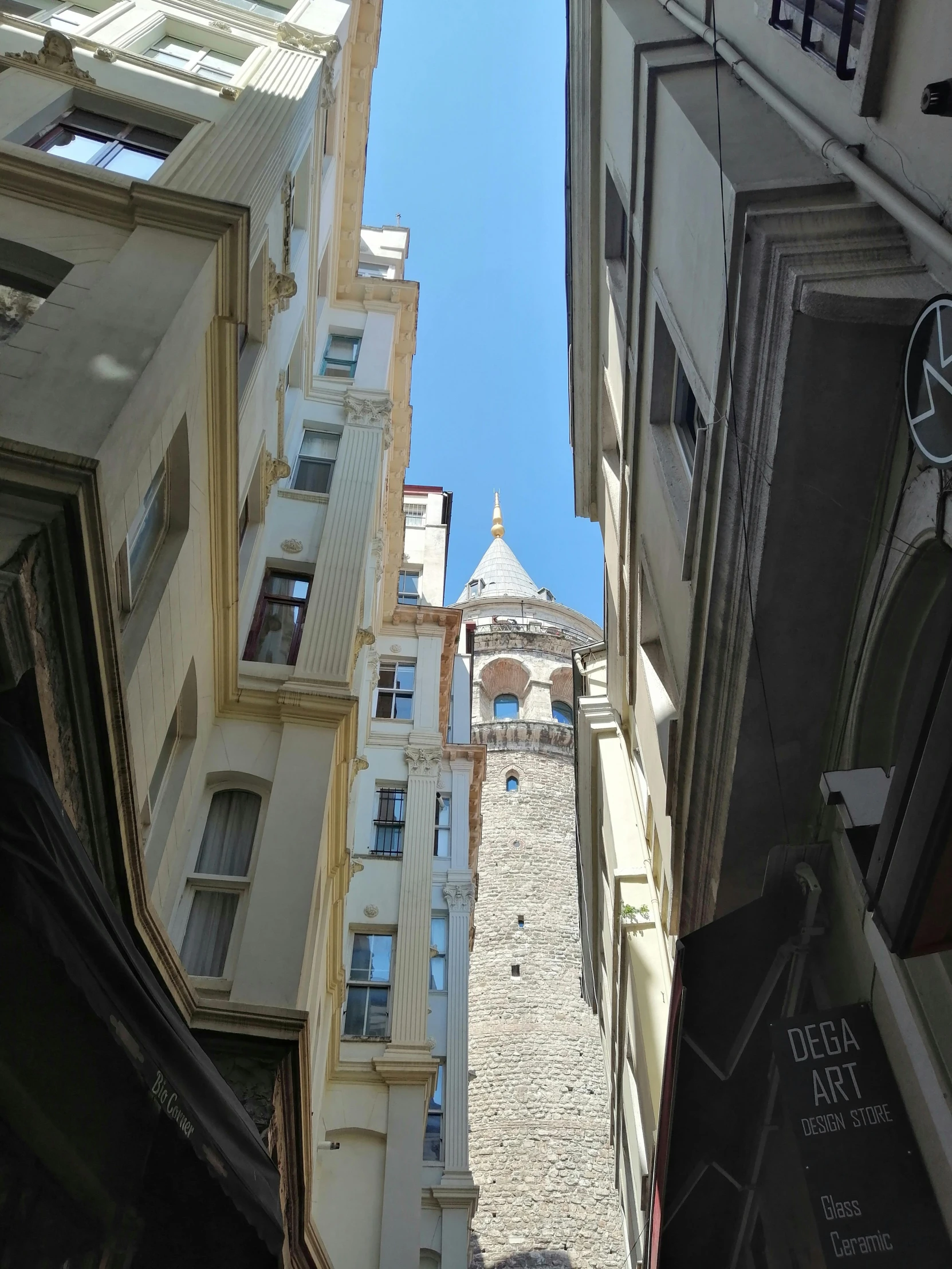 looking up at tall buildings down a narrow alley