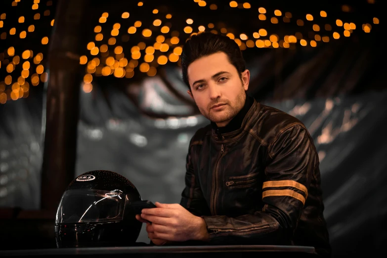 man sitting in a chair with a motorcycle helmet