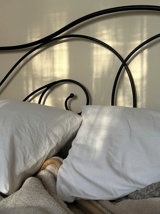 a close up image of a bedroom with white linen