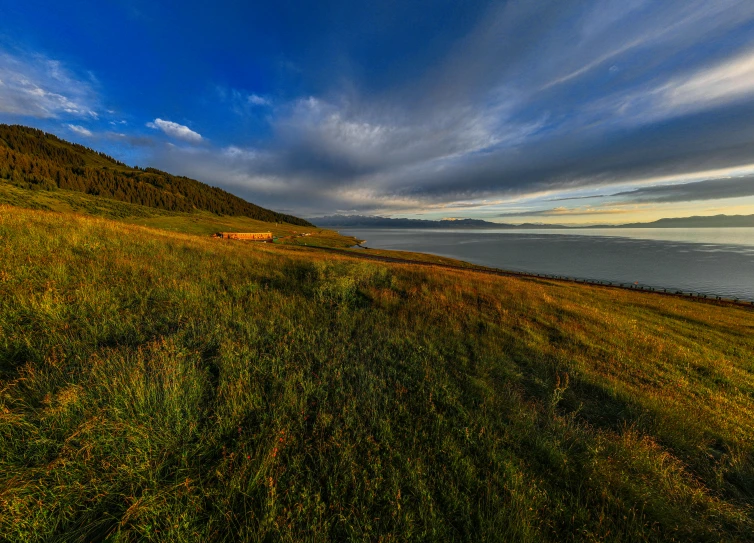 the grassy hill is on the other side of the ocean