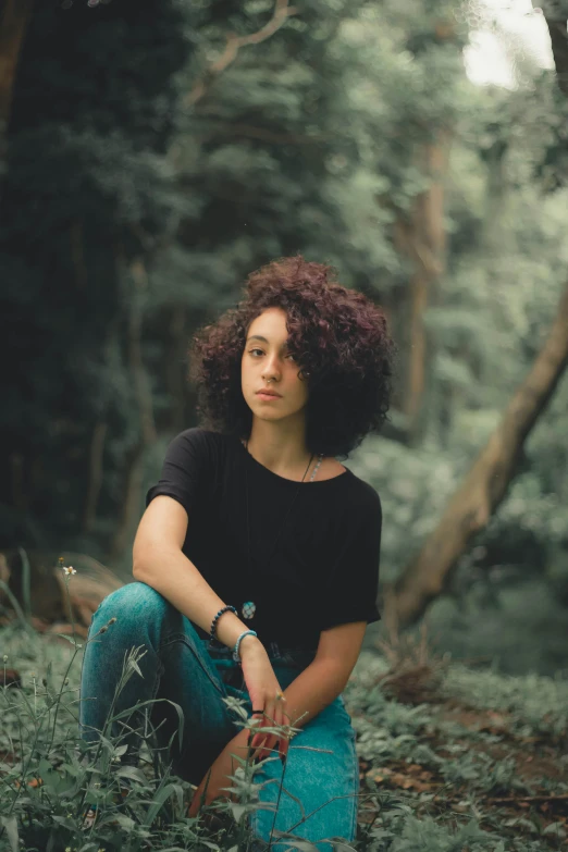 a beautiful young woman posing in a forest