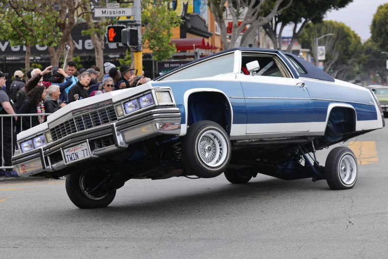 a car is driving through the street with a huge truck on its back