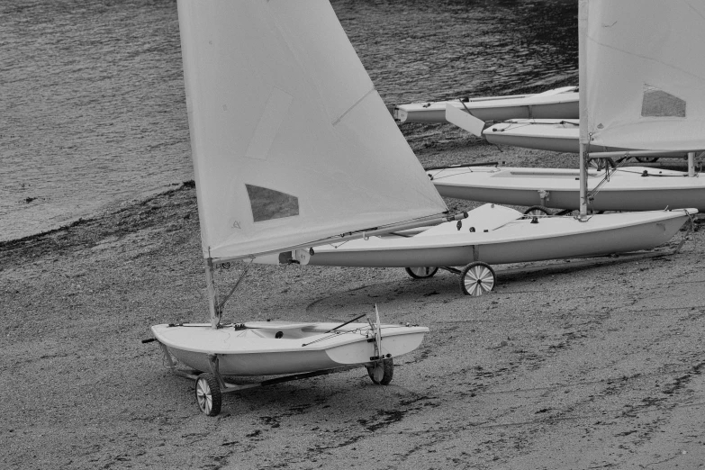 two sail boats are sitting side by side