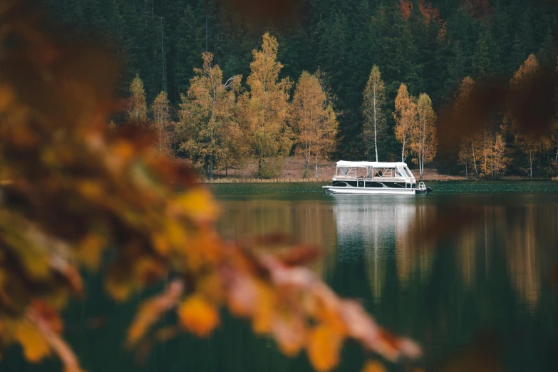 a boat is floating in the calm lake