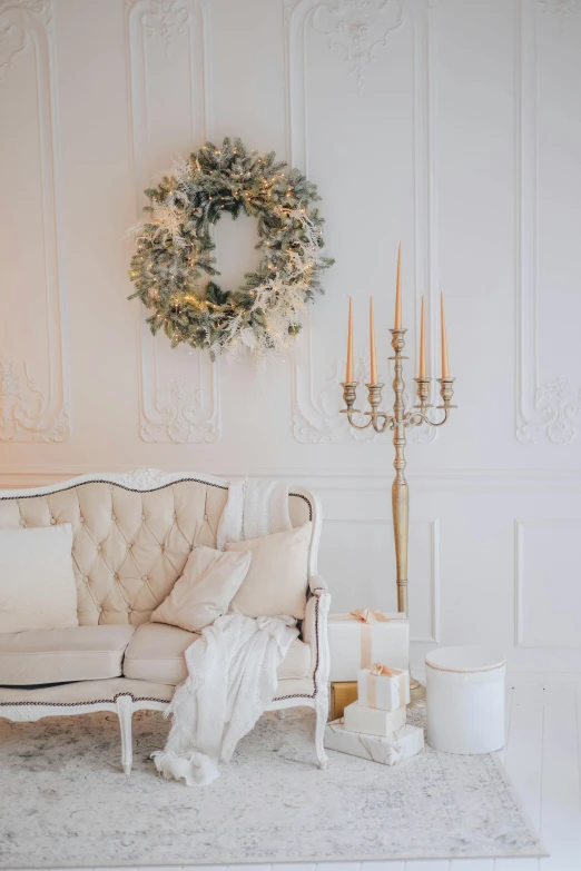 a white couch with a white cover and a candle in front of it