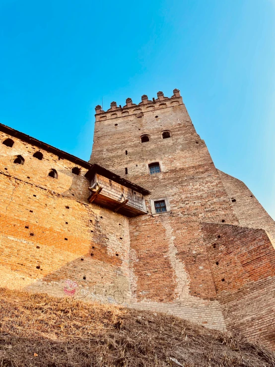 this building has a tower and is next to a wall