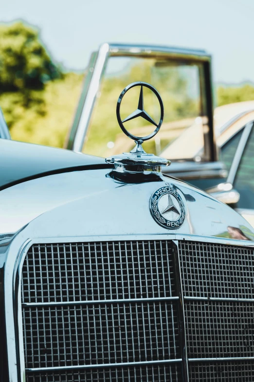 a mercedes logo and other cars parked together