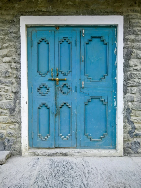 an old stone building with a blue door