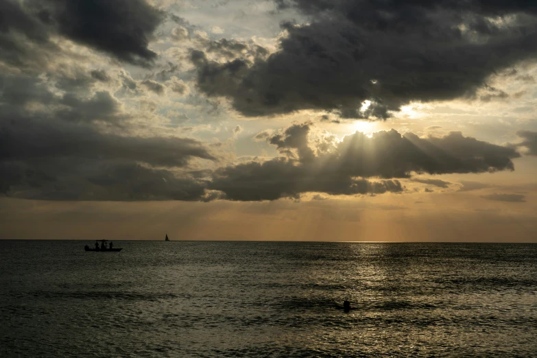 a beautiful sunset reflects off the water off the coast of a city