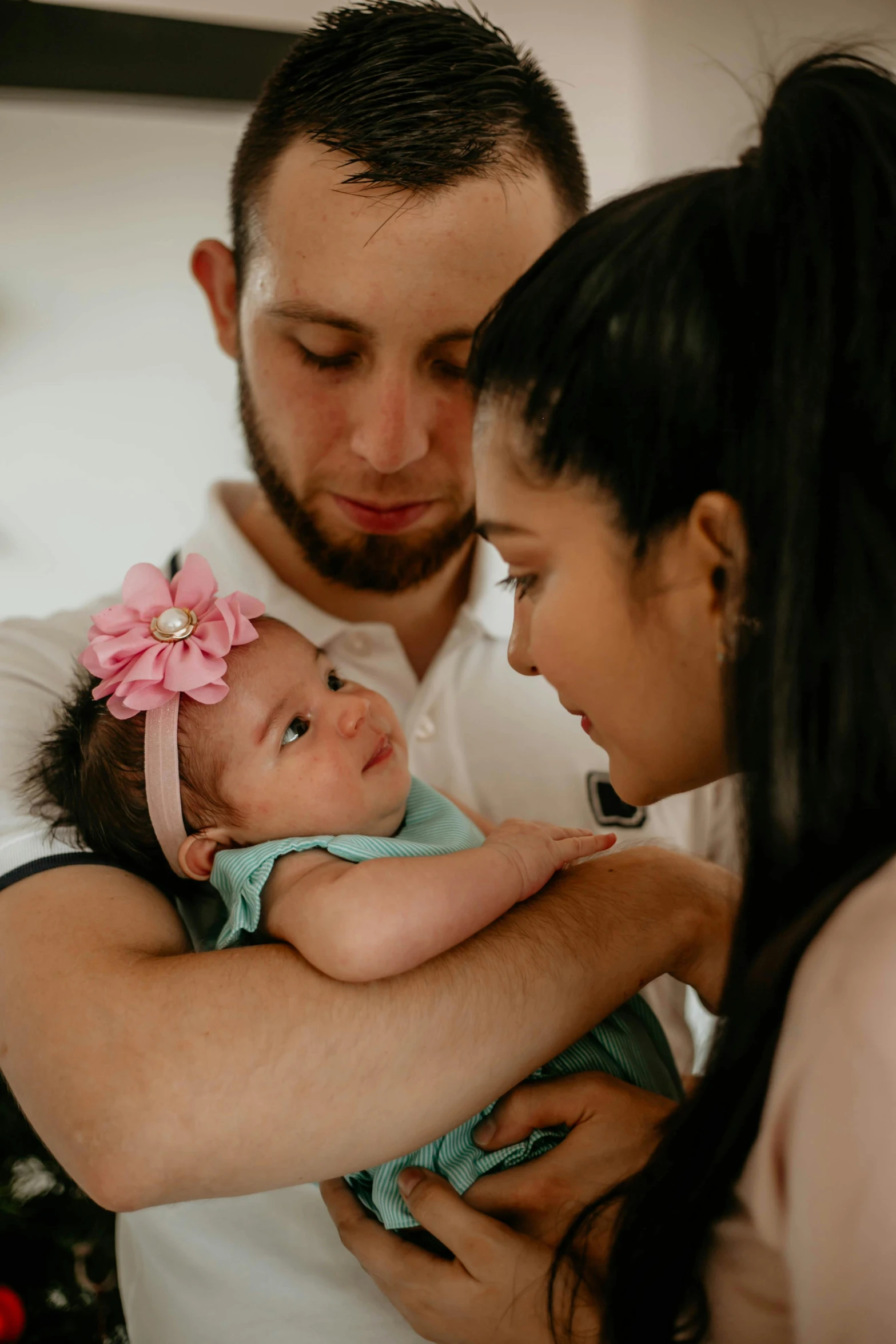 a man and woman holding a baby